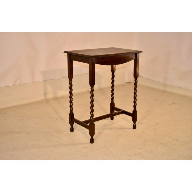 Period Edwardian oak side table from England, circa 1900. The top of this piece is nicely grained and has a beveled edge,...
