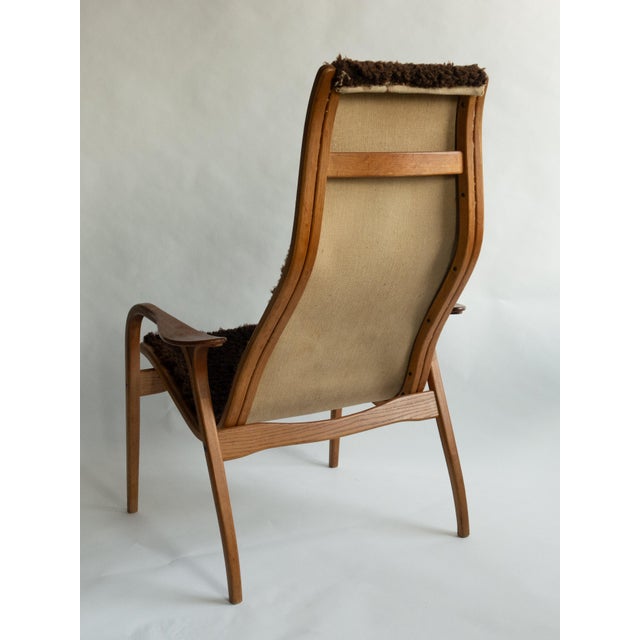 Lamino lounge chair designed by Yngve Ekström for Swedese, Sweden. Bentwood laminated frame with brown sheepskin...