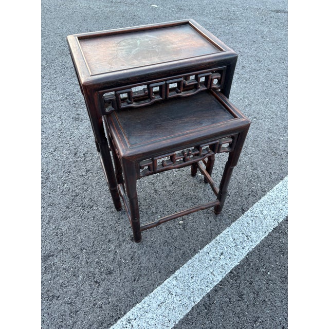 Hongmu Style Nesting Tables comes in a Dark Wood Hand Carved Style made in Hong Kong in a thoughtful design .