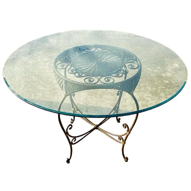 Quality made vintage heavy wrought iron with four woven wicker chairs and matching round table base with glass top. There...