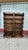 Sturdy pair of wooden bookcases with a dark brown finish. Each unit has five shelves and features decorative scalloped...
