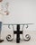 This side table makes its impression through glass top, black wrought iron H-form base. The piece dates to 20th Century,...