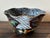 Glossy black hand-panted Italian bowl with scroll details surrounding the pedestal base. Painted with trellis, leaf, and...