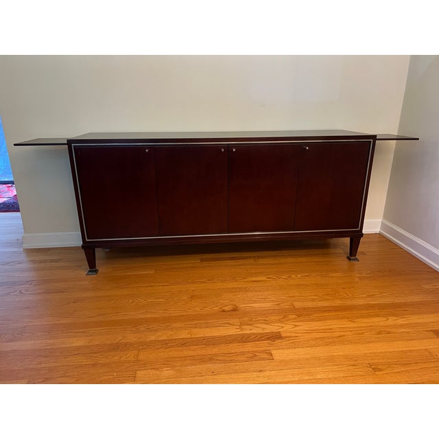 Offering a Mahogany Sideboard from the Barbara Barry Collection for Baker Furniture. Finished in a dark mahogany, the...