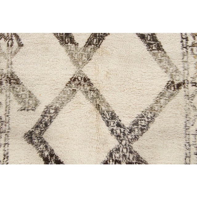 Hand-knotted in wool and originating circa 1950-1959, this 5x10 vintage Moroccan berber runner joins Rug & Kilim’s...