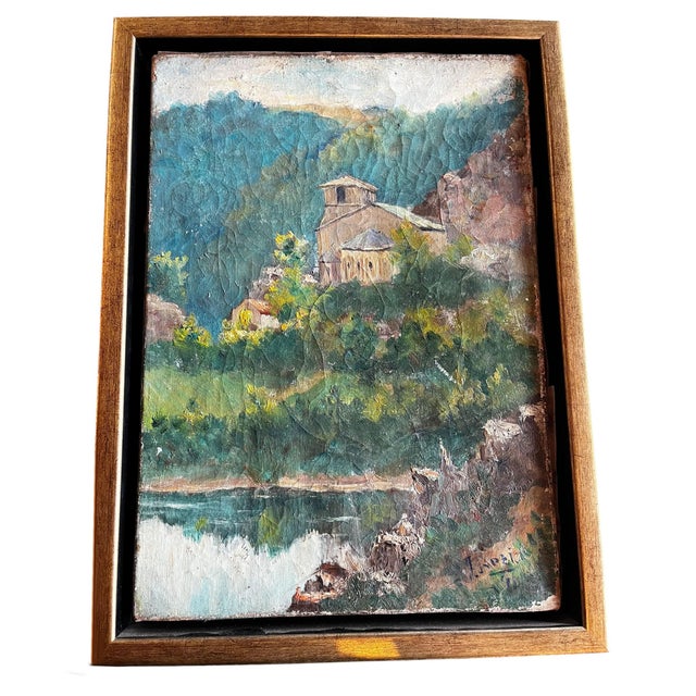 A charming Spanish oil on canvas depicting a peaceful countryside scene with a hillside chapel overlooking still waters...