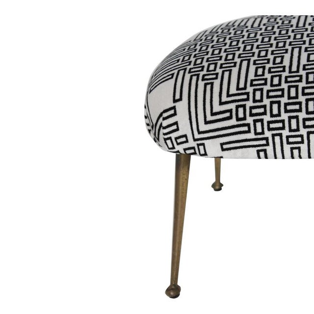 Elegant Italian footstool from the 1950s, upholstered in white fabric with a striking black geometric pattern. The piece...