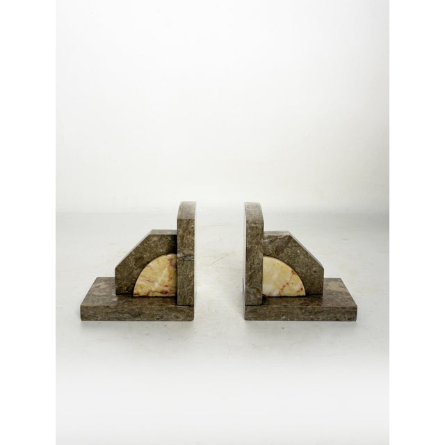 Pair of marble bookends, France, 1950s, with an elegant geometric design typical of the period's decorative style. Each...