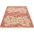 Handwoven Chinese area rug featuring a floral motif on a coral/terracotta colored field accented in shades of ivory,...
