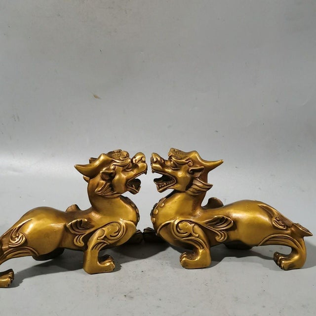 Add a touch of Eastern mystique and protective energy to your space with this striking pair of vintage-style brass...
