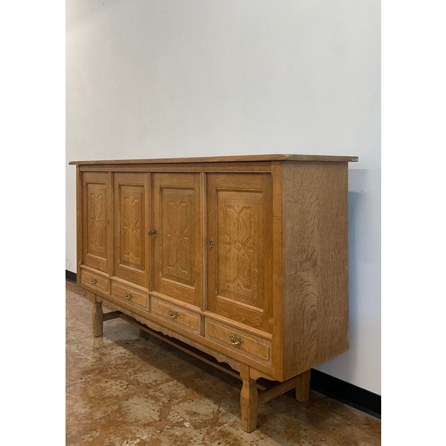 A very handsome highboard in oak with lovely carved details. Attributed to Henry Kjærnulf and likely made by EG Mobler in...