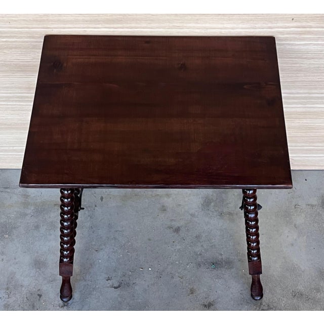 19th Spanish side table with turned legs and iron stretcher. The top has a beautiful grain and patina.