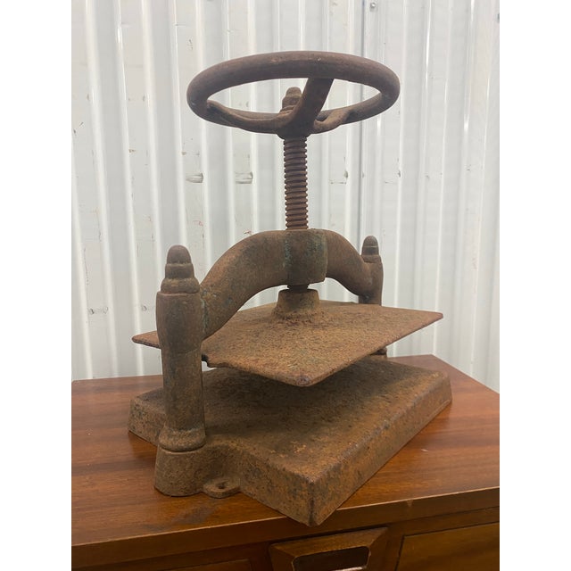 Vintage cast iron book press, likely dating back to the late 19th century. These devices were historically used to secure...