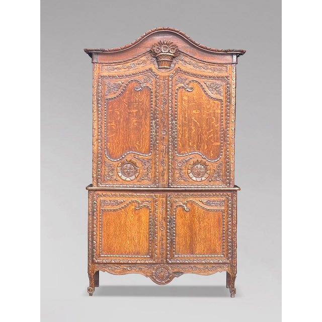 An 18th-century carved oak louis xvi buffet deux corps cupboard a good example of norman craftsmanship, this impressive...
