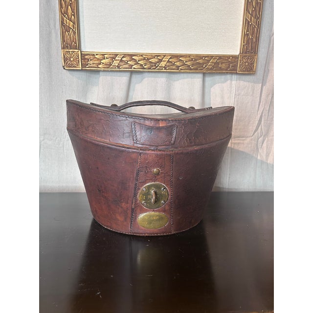 Period men’s, very dapper, top hat made in London, England for J F Kloeg along with it’s wonderfully aged leather carrying...