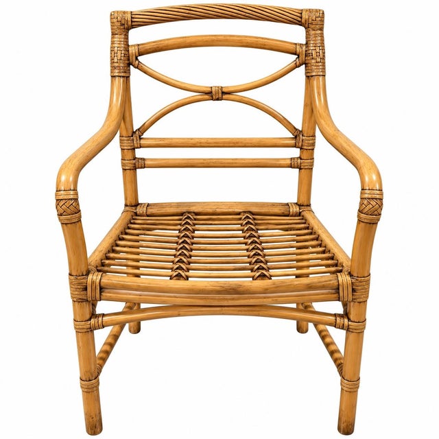Beautiful pair of vintage McGuire San Francisco rattan armchairs featuring sculptural crossed backs, wrapped joints, woven...