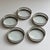 Elevate your bar cart or cocktail table with this elegant set of five vintage silver-plated gallery coasters. Each coaster...