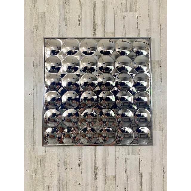 Plexiglass convex bubble designed mirror with a silver metal frame for that pop art ambiance of reflective materials.