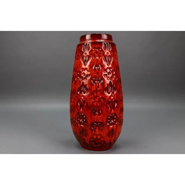 Vibrant 1970s bay keramik “fat lava” vase, west germany, featuring a bold red glaze with textured floral relief. A...