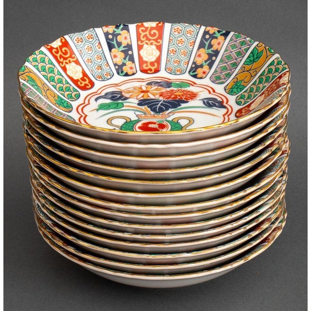 Imari Fan Arita Porcelain Dinnerware Service, each with gilt borders and marked "Imari Fan / I Magnin Exclusive / Arita...