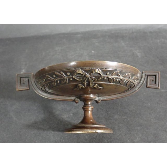 This antique footed centerpiece bowl is a 19th-century French Neo-Grec patinated bronze tazza, cast by the world-renowned...
