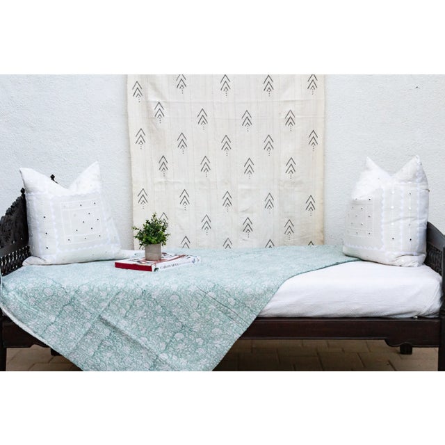 Inspired by traditional Indian kantha quilts, this cotton coverlet features a block-style print of tribal designs and...
