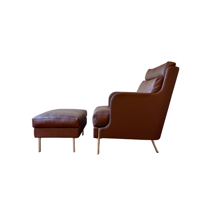 This striking High Back Lounge Chair and Ottoman, upholstered in premium Chocolate colored leather, is designed by Pierre...