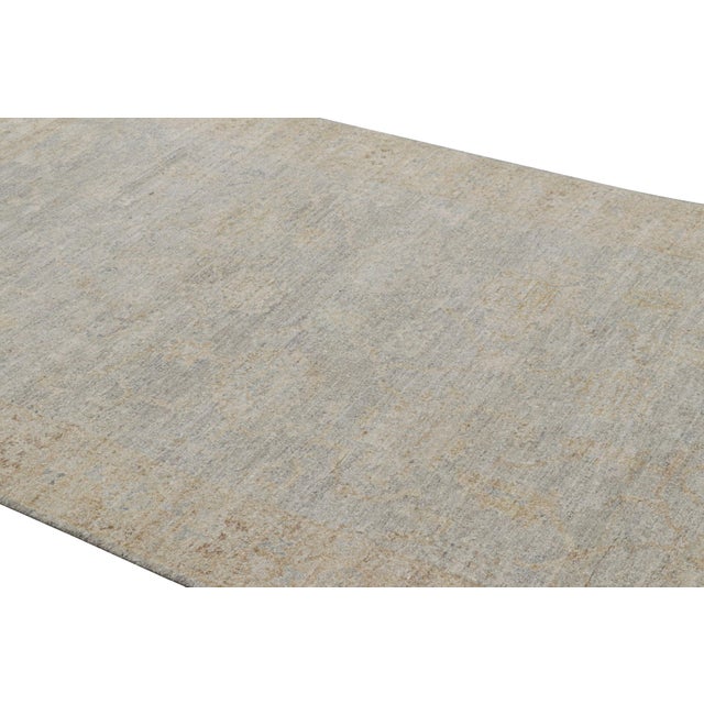 Made with hand-knotted silk and featuring floral patterns in beige-brown, gray and off-white tones, this 5x8 rug from Rug...