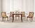 An elegant set of six French Empire-style side dining chairs, each featuring a remarkable carved swan neck decorative...