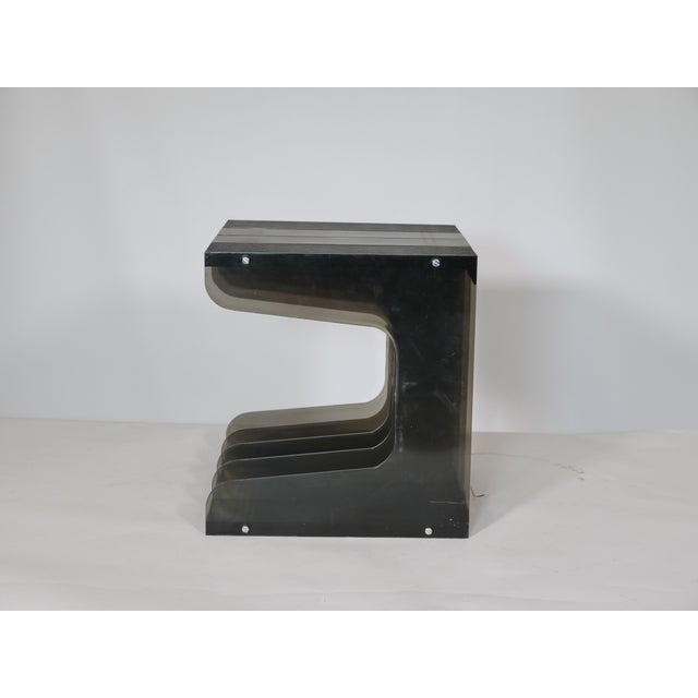 Space Age record stand made of smoked acrylic from the 1970s. The stand features four compartments for storing LPs and...