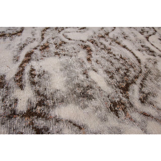 Beautiful Persian Tabriz hand-knotted wool rug with tan and brown distress field. This Tabriz rug was made in Iran and its...