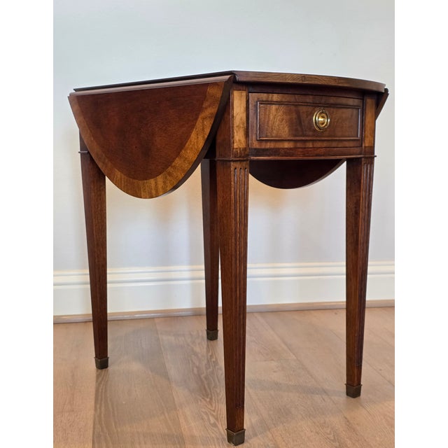 A stunning classic early American Federal style mahogany pembroke occasional table by renowned fine quality American...