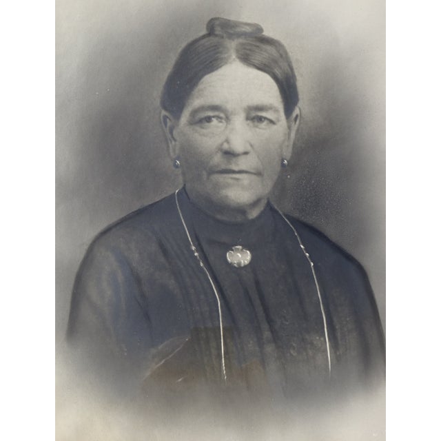 Antique solid beechwood frame with regular embossed motifs of circles and leaves. Black and white photograph in a beige...