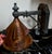This Arts and Crafts Hammered Copper Wall Sconce features a black metal arm with a corded cone shade, adding a touch of...