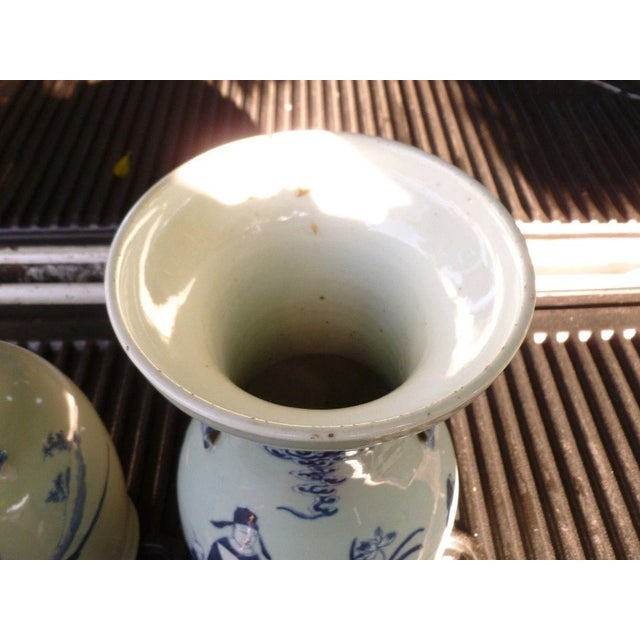 Fine unmatched pair 19th C Qing Dynasty Chinese blue & white on celadon ground vases measuring 16.75 inches each, both in...