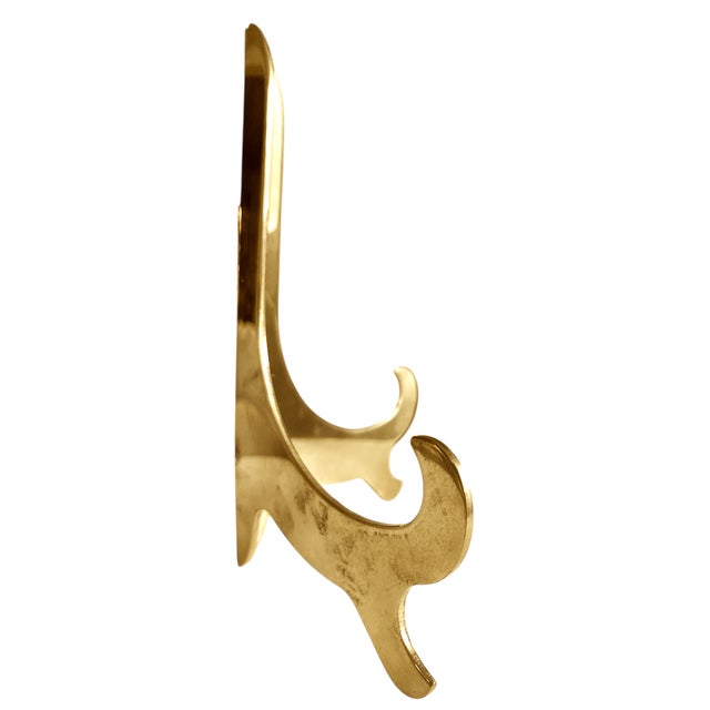 Classic lacquered brass easel or plate stand with high sheen. Sturdy and substantial.