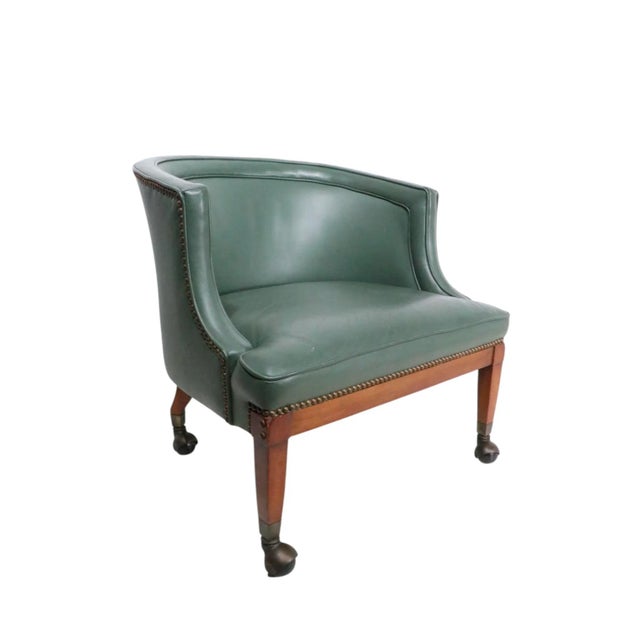 Exceptional leather tub chair with nailhead stud trim, and hooded ball coaster feet. The sophisticated, tailored and clean...