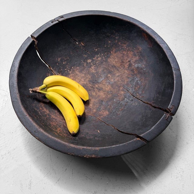 An exceptionally weathered Japanese wooden kibachi, hand-hollowed from solid wood, with a deep rounded form and a...