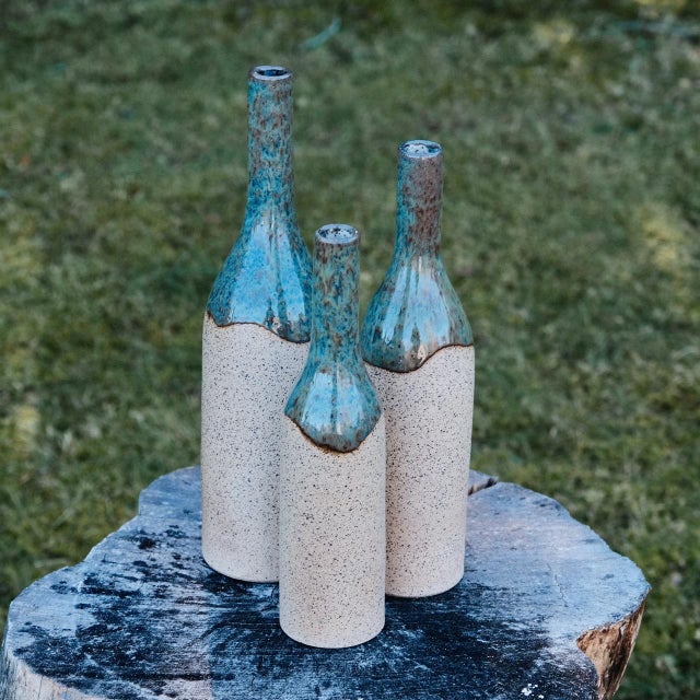 Decorative bottle vase, wheel-thrown from speckled stoneware and coated with "Satin Clear" inside and "Arctic Blue" glaze...