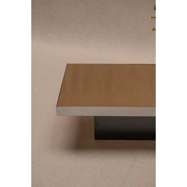 Elegant French Space Age coffee table from the 1970s, distinguished by its refined geometric proportions, reflective...