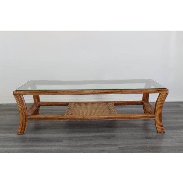 Vintage pencil reed coffee table with glass top Dimensions; 52" Width x 22" Depth x 16" Height This table has minor wear...