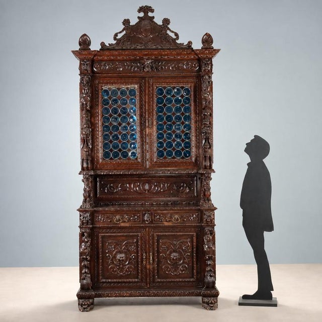 Neo-Baroque walnut sideboard, finely carved, from late 19th century Italy. The upper section features a pair of leaded...