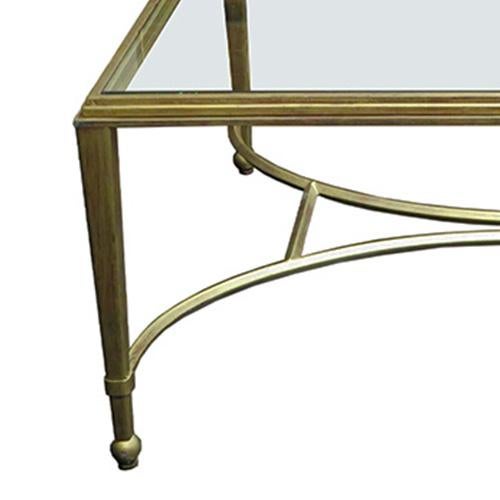 Hollywood Regency coffee table with a rectangular wrought iron base in gold leaf. The top border features a three step...