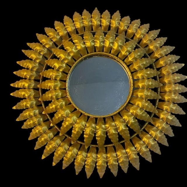 Round sun mirror in wrought iron from the 1950s. Italian artisanal fabrication, decor of leaves.