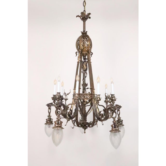 Features Neo-Rococo scrollwork along the arms, griffins on the end of the arms, a salamander on the upper side of the...