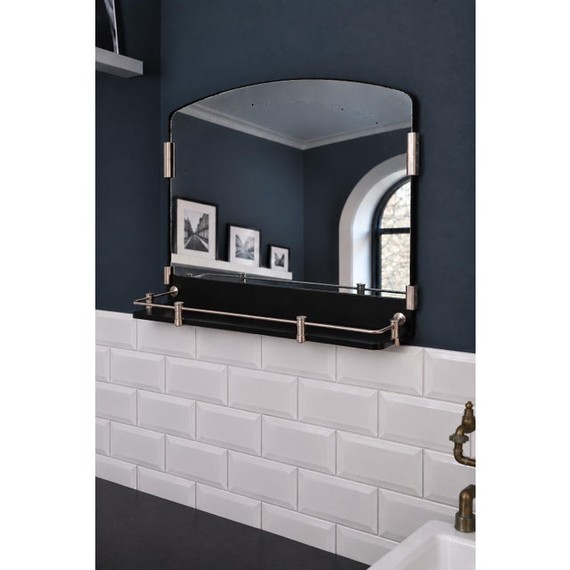 Art Deco bathroom wall mirror, France, 1930s-40s. The mirror has a curved top, and the shelf and gallery are a single...