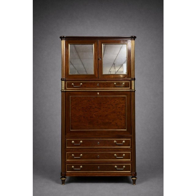 A louis xvi period parisian guillotine-style secretary desk in mahogany and gilt brass, resting on tapered legs ending in...