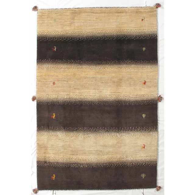Vintage Hand-knotted Persian Lori Gabbeh rug featuring alternating horizontal bands in warm beige and deep brown, accented...