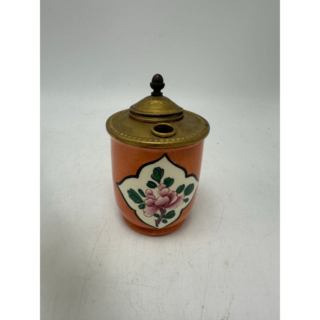 This is a charming French porcelain inkwell set (often called a desk inkwell or writing stand inkwell). The small...