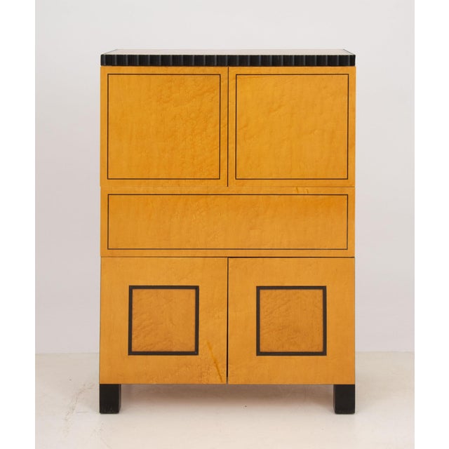 Richard Bloch Birds Eye Maple Cabinet, with ebonized trim, two-door cabinet above lift-top drawer and bottom two-door...